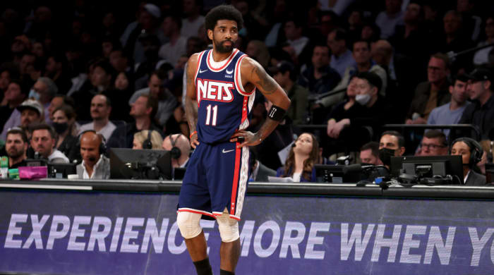 Nets guard Kyrie Irving stands on the sideline in Brooklyn.